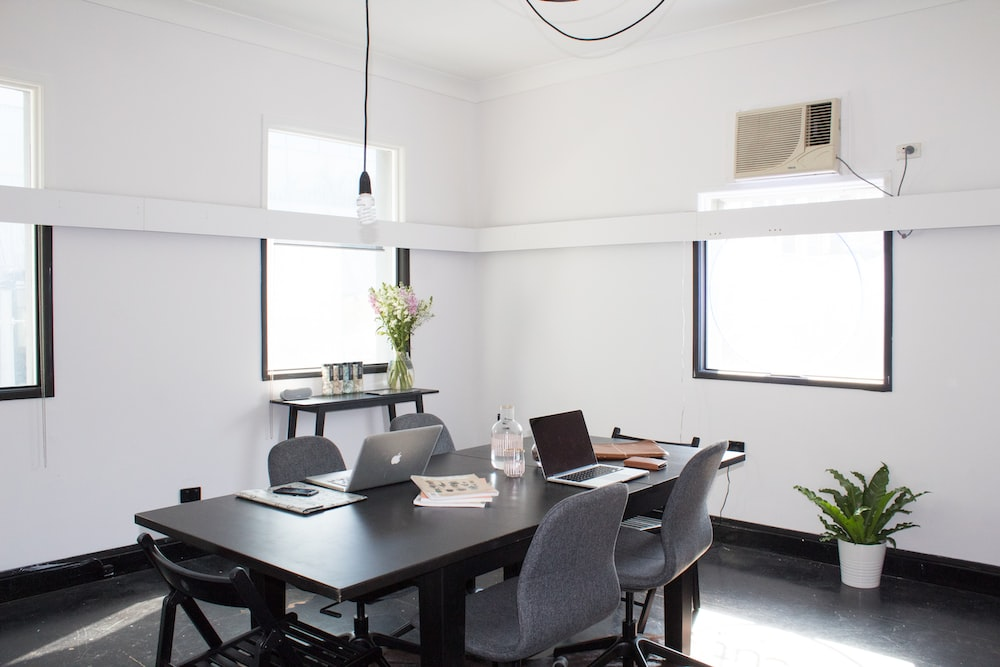  A clean office and meeting room with grey furniture
